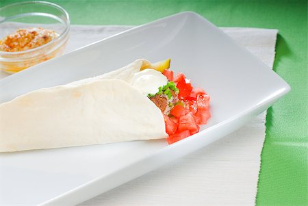 fresh traditional falafel wrap on pita bread with fresh chopped tomatoes Stock Photo - Budget Royalty-Free & Subscription, Code: 400-04397297