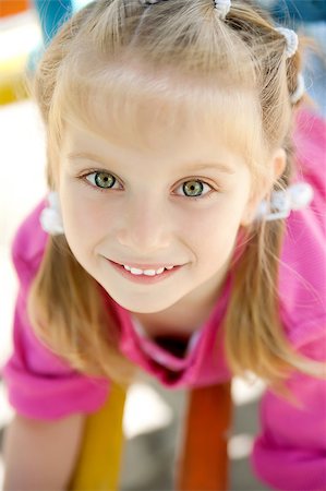 cute little girl smiling in a park close-up Stock Photo - Budget Royalty-Free & Subscription, Code: 400-04397355