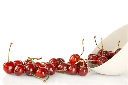 simsearch:400-08341539,k - Sweet red cherries and ceramic bowl isolated on a white background Stockbilder - Microstock & Abonnement, Bildnummer: 400-04397479