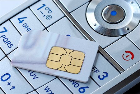 sim card - Close-up of the keypad and the sim card of a cellular phone Stock Photo - Budget Royalty-Free & Subscription, Code: 400-04397695
