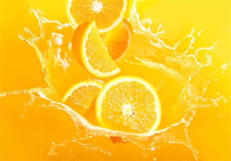 Fresh oranges falling in juice with lot of huge splashes Stock Photo - Budget Royalty-Free & Subscription, Code: 400-04398162