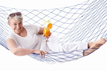 Mature woman with a cocktail in a hammock isolated Stock Photo - Budget Royalty-Free & Subscription, Code: 400-04398295