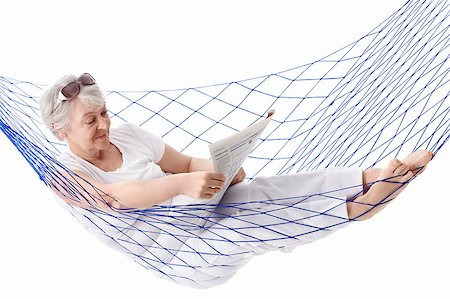 Mature woman reading a newspaper in a hammock on a white background Stock Photo - Budget Royalty-Free & Subscription, Code: 400-04398297