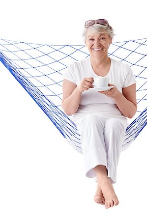 The senior woman with a cup of coffee in a hammock on a white background Stock Photo - Budget Royalty-Free & Subscription, Code: 400-04398299