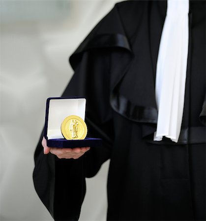 This photograph represents lawyer wearing a robe holdong a a justice medal with sword and scale. Photographie de stock - Aubaine LD & Abonnement, Code: 400-04398428