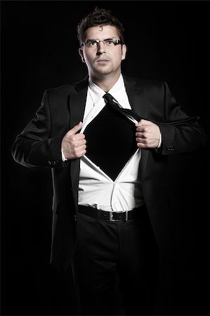 A picture of a young handsome man tearing off his shirt over black background Stock Photo - Budget Royalty-Free & Subscription, Code: 400-04398523