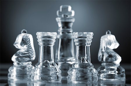 glass chess pieces are defending the king on board in dark Photographie de stock - Aubaine LD & Abonnement, Code: 400-04398586