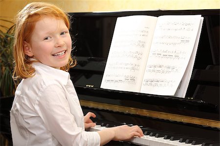 piano practice - Portrait of a happy young girl playing piano Stock Photo - Budget Royalty-Free & Subscription, Code: 400-04398712