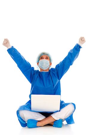 doctor with cap and mask - female surgeon who rejoices with laptop Stock Photo - Budget Royalty-Free & Subscription, Code: 400-04398933