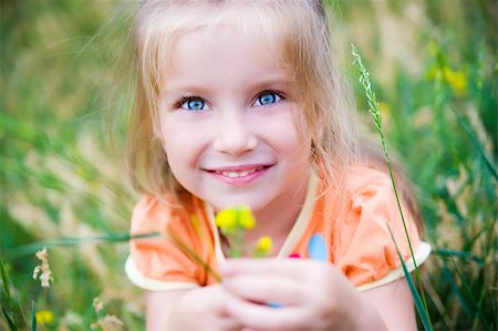 Cute little girl  on the meadow in summer day Stock Photo - Budget Royalty-Free & Subscription, Code: 400-04399399