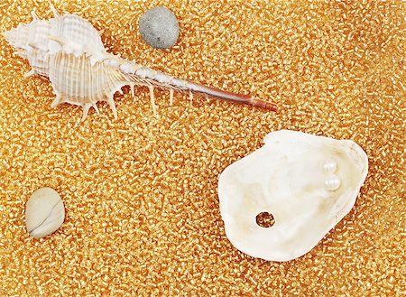 seashell photo concept - marine cockleshells and stones on by gold the beads Stock Photo - Budget Royalty-Free & Subscription, Code: 400-04399449