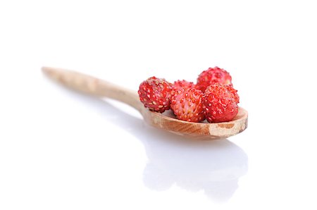 simsearch:400-04812854,k - Strawberries in small wooden spoon with soft shadow on white background. Shallow depth of field. Photographie de stock - Aubaine LD & Abonnement, Code: 400-04399457