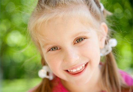 simsearch:400-05342069,k - cute little girl smiling in a park close-up Stock Photo - Budget Royalty-Free & Subscription, Code: 400-04390382