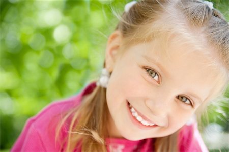 simsearch:400-05342069,k - cute little girl smiling in a park close-up Stock Photo - Budget Royalty-Free & Subscription, Code: 400-04390383