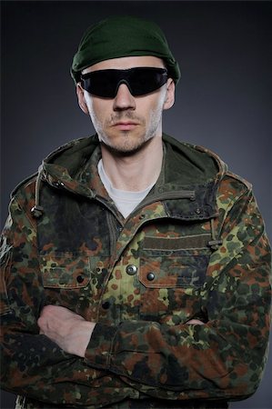 paintball - portrait of soldier in camouflage and ammunition . studio shot Fotografie stock - Microstock e Abbonamento, Codice: 400-04390873