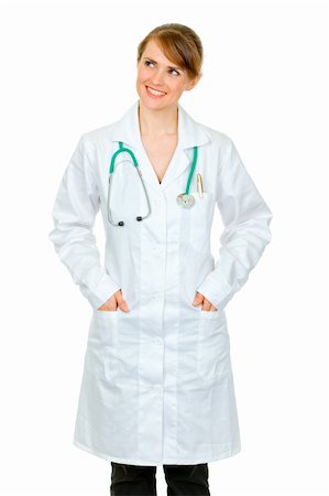 simsearch:400-04351236,k - Smiling medical doctor woman with hands in pockets of robe looking at copy space isolated on white Stock Photo - Budget Royalty-Free & Subscription, Code: 400-04391104