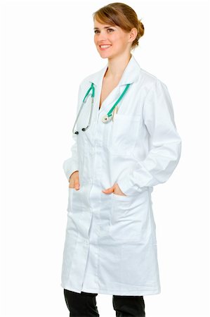 simsearch:400-04351236,k - Smiling medical female doctor with hands in pockets of robe looking at copy space isolated on white Photographie de stock - Aubaine LD & Abonnement, Code: 400-04391102