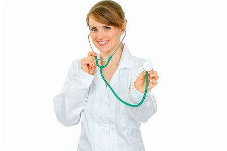 simsearch:400-04351236,k - Smiling medical female doctor holding up stethoscope isolated on white Photographie de stock - Aubaine LD & Abonnement, Code: 400-04391116