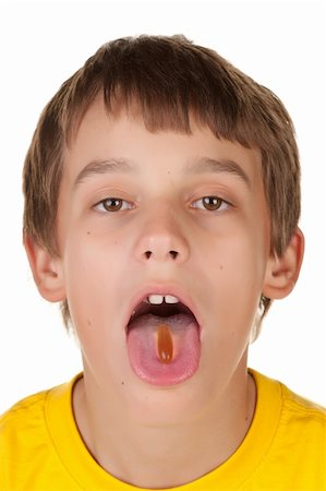 young teenage boy taking a pill on tongue Stock Photo - Budget Royalty-Free & Subscription, Code: 400-04391152
