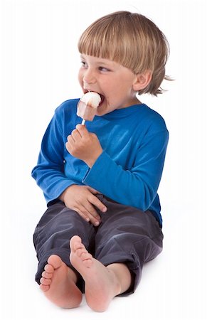 funny freezing cold photos - small boy eating ice lolly on white background Stock Photo - Budget Royalty-Free & Subscription, Code: 400-04391203