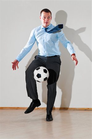 caucasian business man is playing football at office near white wall Stock Photo - Budget Royalty-Free & Subscription, Code: 400-04392490