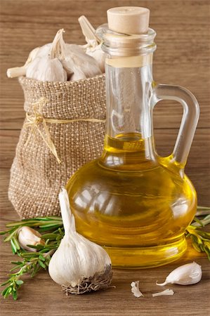 simsearch:400-04393618,k - Garlic, olive oil and rosemary on a wooden table. Foto de stock - Royalty-Free Super Valor e Assinatura, Número: 400-04393617