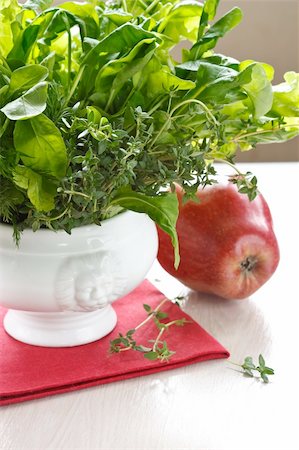 Green salad in a white porcelain bowl and red apple. Stock Photo - Budget Royalty-Free & Subscription, Code: 400-04393720