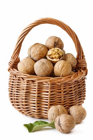 simsearch:400-04415203,k - Garden walnuts in a wicker basket on a white background. Fotografie stock - Microstock e Abbonamento, Codice: 400-04393771
