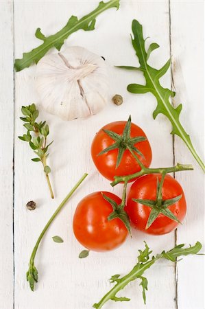 simsearch:400-04393823,k - Tomatoes, arugula, garlic and thyme on a white wooden boards. Stockbilder - Microstock & Abonnement, Bildnummer: 400-04393786