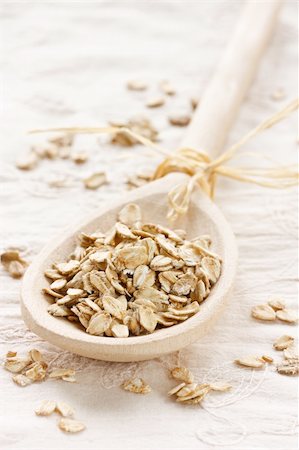 raw oats - Raw thick rolled oats in a wooden spoon. Stock Photo - Budget Royalty-Free & Subscription, Code: 400-04393792