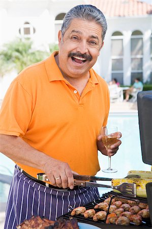 Man Barbequing In A Garden Stock Photo - Budget Royalty-Free & Subscription, Code: 400-04404104