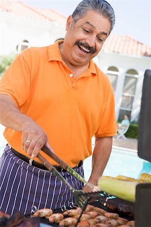Man Barbequing In A Garden Stock Photo - Budget Royalty-Free & Subscription, Code: 400-04404100