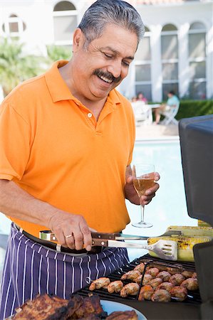 Man Barbequing In A Garden Stock Photo - Budget Royalty-Free & Subscription, Code: 400-04404103