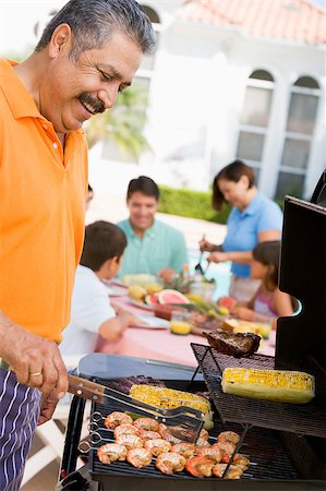 Family Enjoying A Barbeque Stock Photo - Budget Royalty-Free & Subscription, Code: 400-04404116