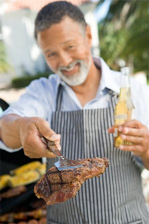 Man Barbequing In A Garden Stock Photo - Budget Royalty-Free & Subscription, Code: 400-04404138