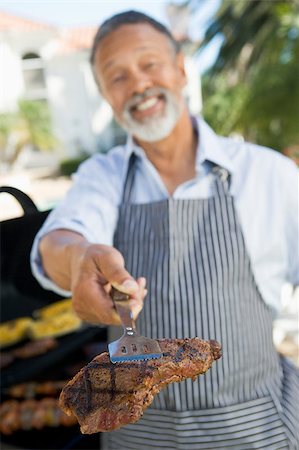 Man Barbequing In A Garden Stock Photo - Budget Royalty-Free & Subscription, Code: 400-04404139