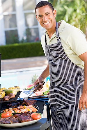 Man Enjoying A Barbequed Meal In The Garden Stock Photo - Budget Royalty-Free & Subscription, Code: 400-04404130