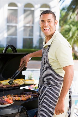 Man Barbequing In A Garden Stock Photo - Budget Royalty-Free & Subscription, Code: 400-04404132