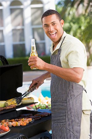 Man Barbequing In A Garden Stock Photo - Budget Royalty-Free & Subscription, Code: 400-04404133