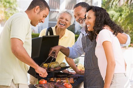 Family Enjoying A Barbeque Stock Photo - Budget Royalty-Free & Subscription, Code: 400-04404144