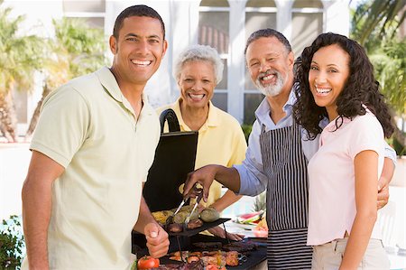 Family Enjoying A Barbeque Stock Photo - Budget Royalty-Free & Subscription, Code: 400-04404145