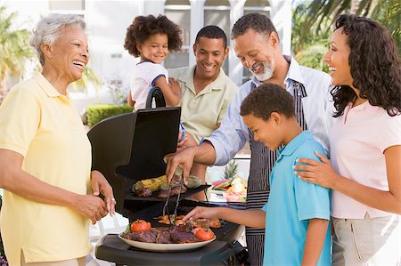 Family Enjoying A Barbeque Stock Photo - Budget Royalty-Free & Subscription, Code: 400-04404148