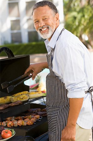 Man Barbequing In A Garden Stock Photo - Budget Royalty-Free & Subscription, Code: 400-04404140