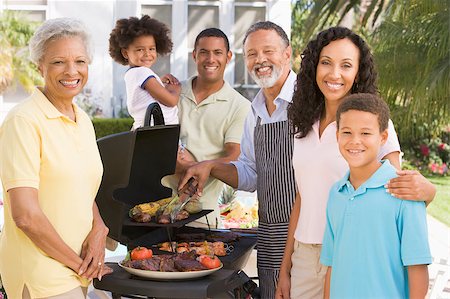 Family Enjoying A Barbeque Stock Photo - Budget Royalty-Free & Subscription, Code: 400-04404157