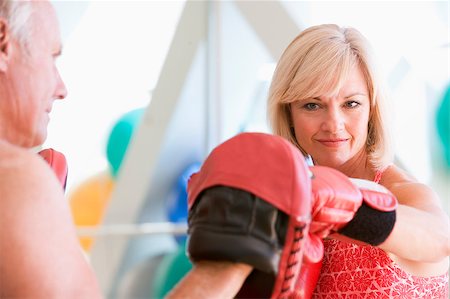 Woman Boxing With Personal Trainer At Gym Stock Photo - Budget Royalty-Free & Subscription, Code: 400-04404372