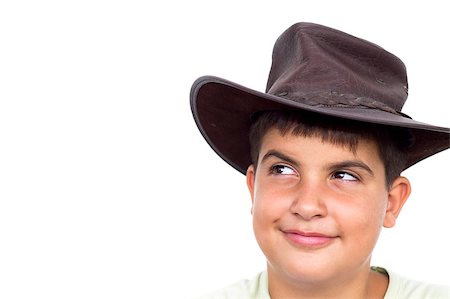 Young cowboy smiling, looking up, on white background Photographie de stock - Aubaine LD & Abonnement, Code: 400-04404431