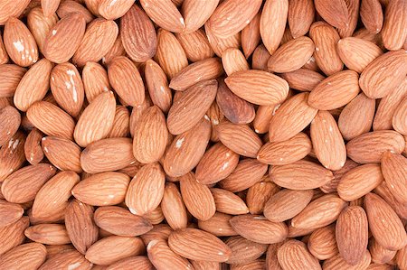 Nuts Almond are scattered as a background on a table. Photographie de stock - Aubaine LD & Abonnement, Code: 400-04404505