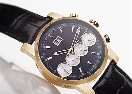 shivanetua (artist) - gold men's wristwatch with black leather strap on a white background Fotografie stock - Microstock e Abbonamento, Codice: 400-04404662