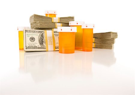 simsearch:400-08862116,k - Empty Medicine Bottles and Stacks of Hundreds of Dollars on Reflective Surface. Stock Photo - Budget Royalty-Free & Subscription, Code: 400-04404884