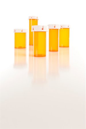 simsearch:400-08862116,k - Several Different Sized Empty Medicine Bottles on Reflective Surface. Stock Photo - Budget Royalty-Free & Subscription, Code: 400-04404883